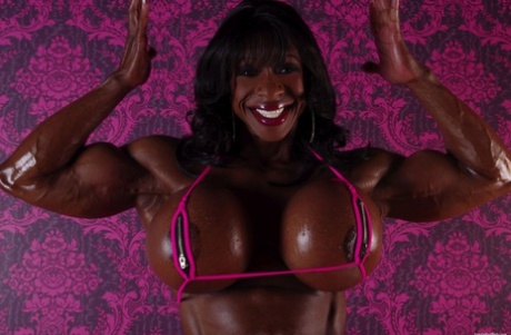 Black bodybuilder Yvette Bova looses her enhanced breasts from a bikini