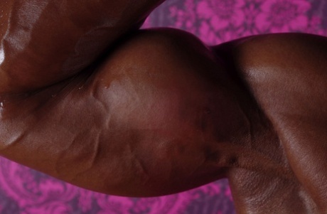 Black bodybuilder Yvette Bova looses her enhanced breasts from a bikini
