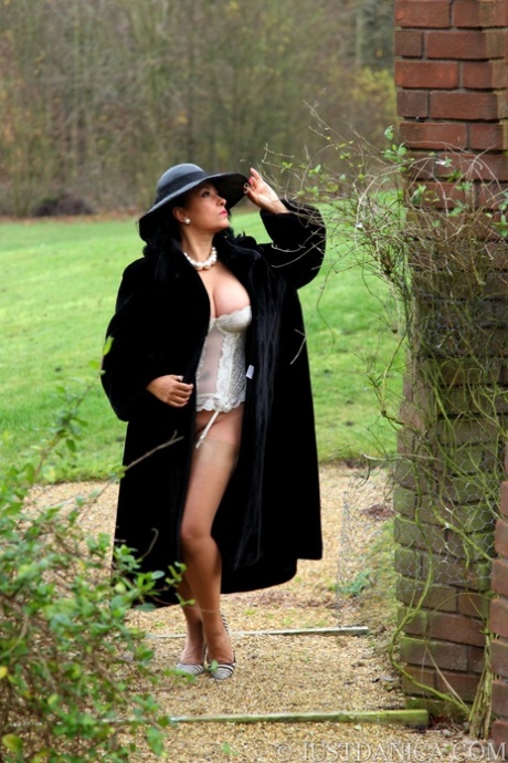Amateur model Danica Collins shows off her big tits and ass outside in a hat