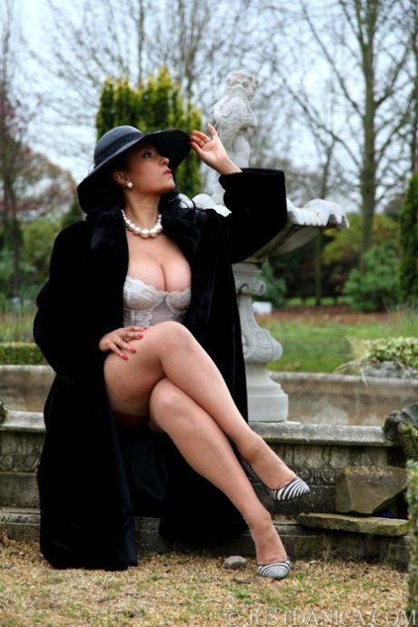 Amateur model Danica Collins shows off her big tits and ass outside in a hat