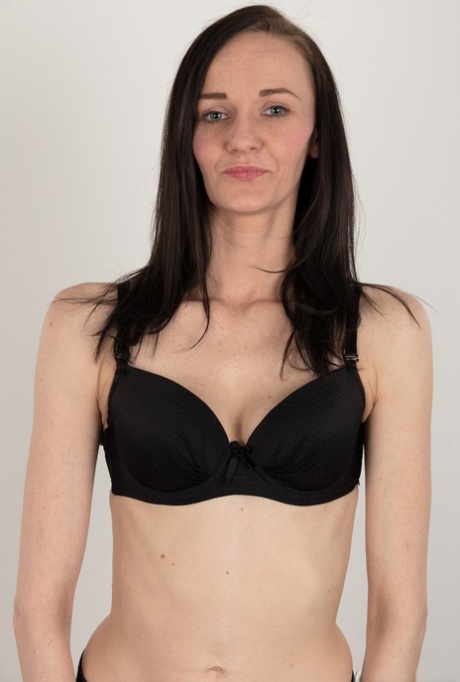 Slender mom with brunette hair stands totally naked in nude modeling debut