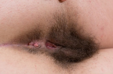 Homely Guadalupe lies on the bed to finger fuck her supremely hairy snatch