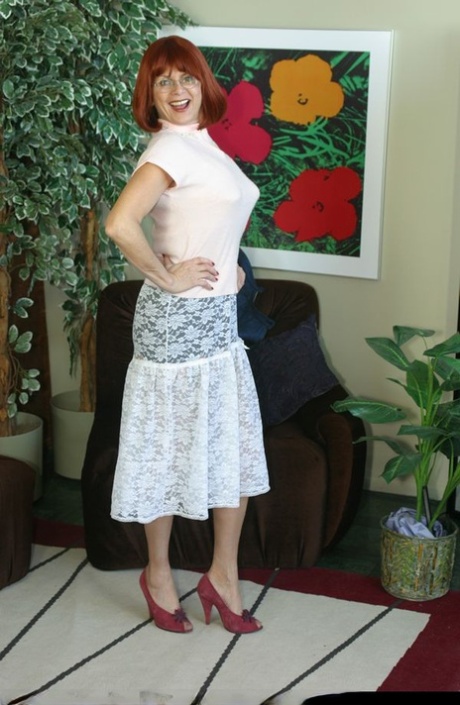 Mature redhead Miss Abigail rubs her twat thru her see thru panties in nylons
