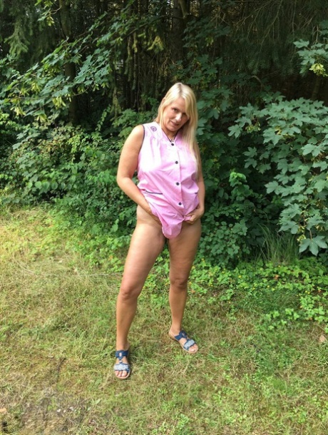 Older blonde amateur Sweet Susi exposes herself in a rural driveway