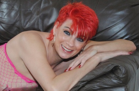 Older redhead Dimonty shows her pretty feet before doffing a mesh bodystocking