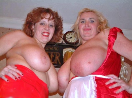 Busty redhead Curvy Claire engages in lesbian sex with a big titted blonde