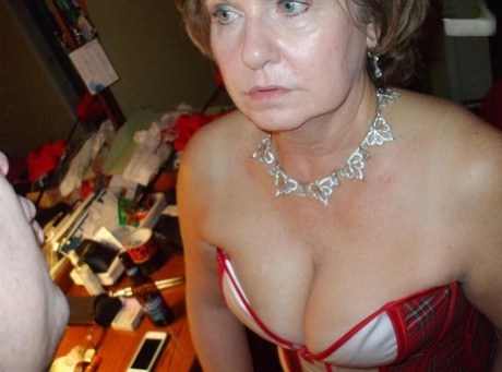 Mature lady Busty Bliss sports nipple clamps after being handcuffed