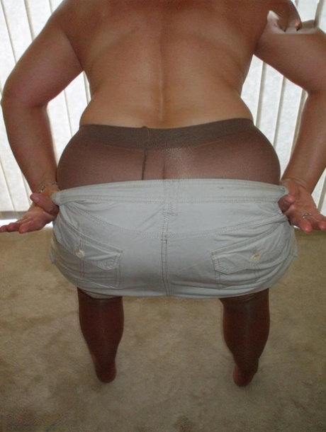 Middle-aged amateur Busty Bliss displays her tan lined tits in pantyhose