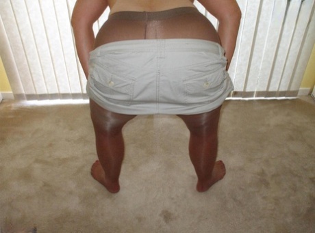 Middle-aged amateur Busty Bliss displays her tan lined tits in pantyhose