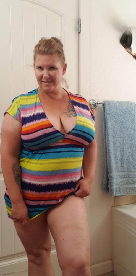Mature BBW Kris Ann removes a dress before taking a shower in the nude
