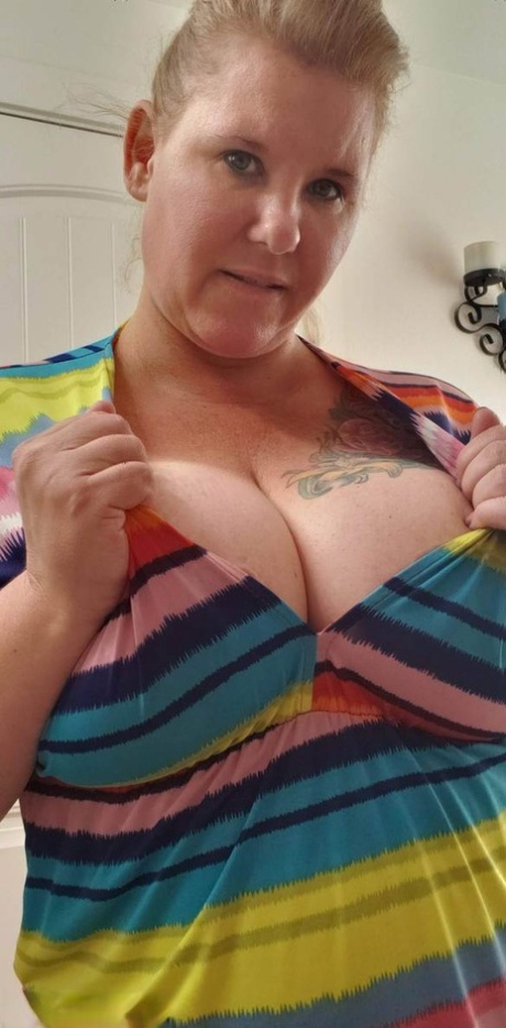 Mature BBW Kris Ann removes a dress before taking a shower in the nude