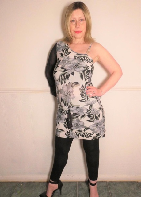 Older amateur Posh Sophia models pink lingerie before changing into a dress