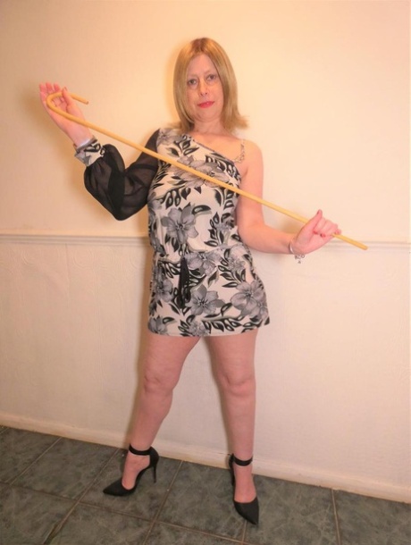 Older amateur Posh Sophia models pink lingerie before changing into a dress
