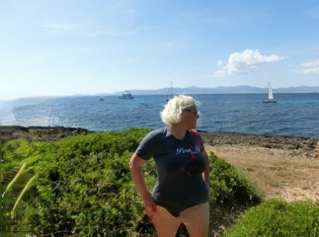 Older platinum blonde Barby gets naked to masturbate at a seaside location