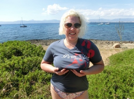 Older platinum blonde Barby gets naked to masturbate at a seaside location