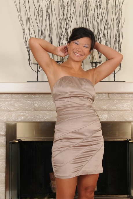 Mature Asian Samantha W exposes hard nipples on small tits & a bald snatch