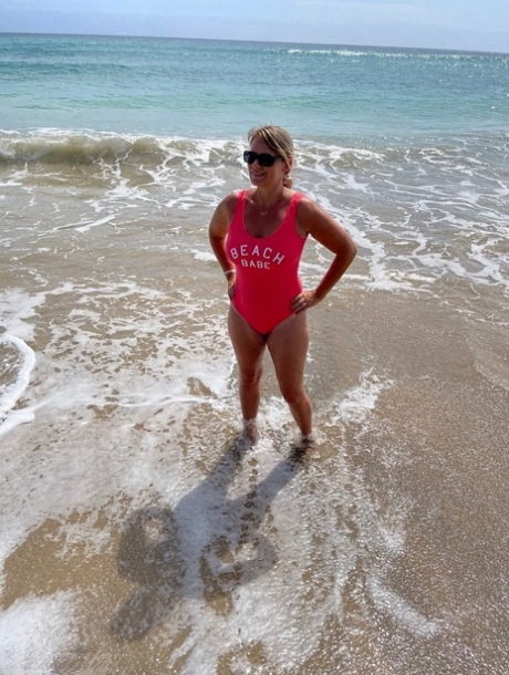 Middle-aged blonde Sweet Susi gets totally naked on a sandy beach
