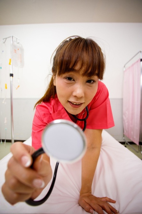 Older Asian nurse Shoko Chiba has POV sex on a bed with a patient