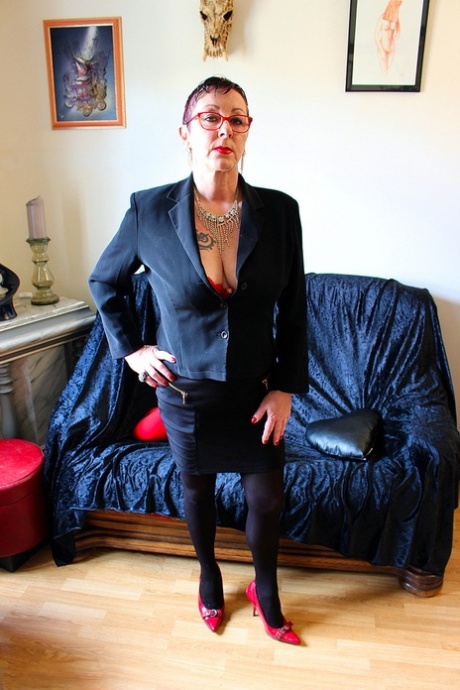 Mature woman Mary Bitch displays her pierced bush in sexy stockings