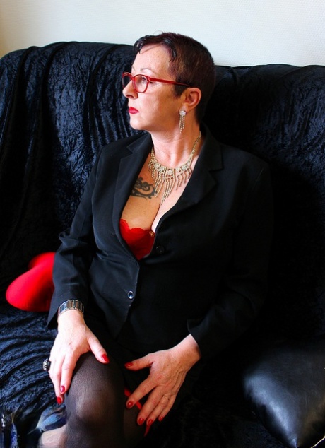 Mature woman Mary Bitch displays her pierced bush in sexy stockings
