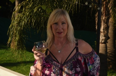 Fat older blonde Melody peels off black leggings afore an outdoor hot tub