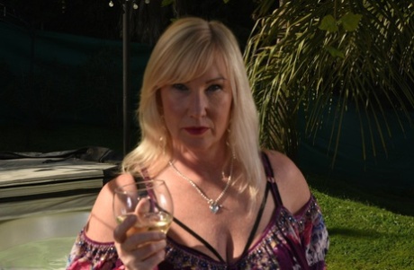 Fat older blonde Melody peels off black leggings afore an outdoor hot tub
