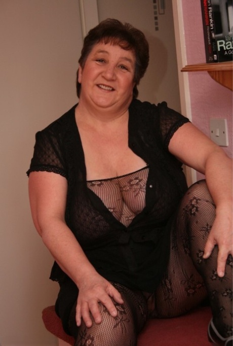 Older BBW Kinky Carol models a sheer bodystocking during solo action