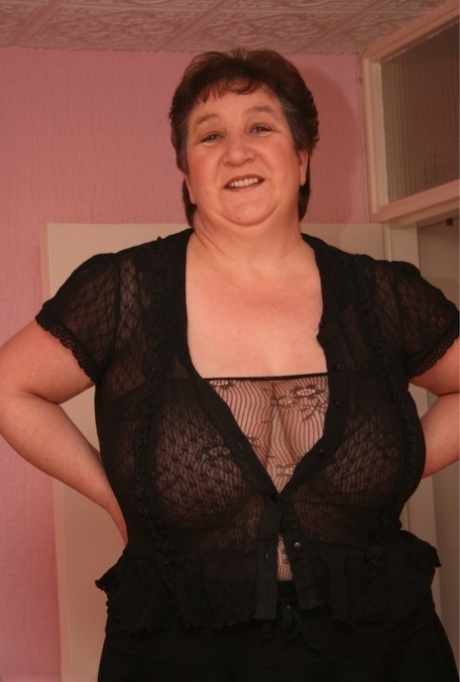 Older BBW Kinky Carol models a sheer bodystocking during solo action