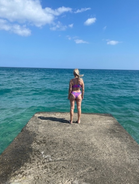 Middle-aged blonde Sweet Susi releases her natural tits and twat from a bikini