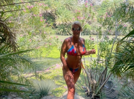 Middle-aged blonde Sweet Susi releases her natural tits and twat from a bikini
