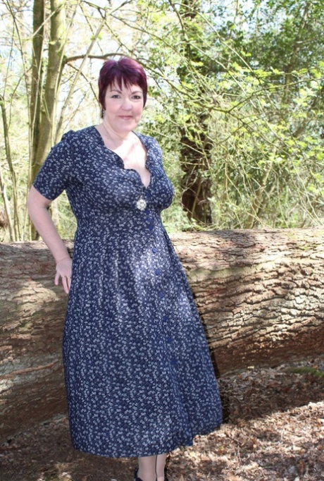 Mature lady with short hair Layla Bird shows her tits and pussy in the woods