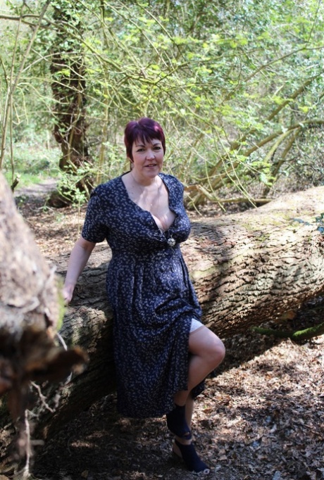 Mature lady with short hair Layla Bird shows her tits and pussy in the woods