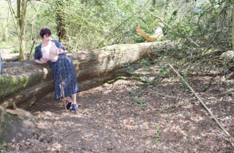Mature lady with short hair Layla Bird shows her tits and pussy in the woods
