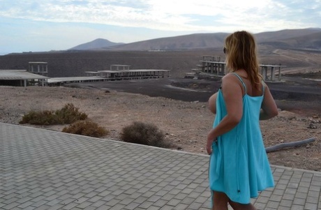 Middle-aged blonde Nude Chrissy shows her naked body at a desolate location