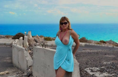 Middle-aged blonde Nude Chrissy shows her naked body at a desolate location