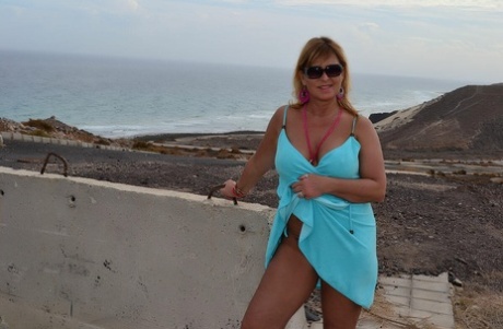 Middle-aged blonde Nude Chrissy shows her naked body at a desolate location