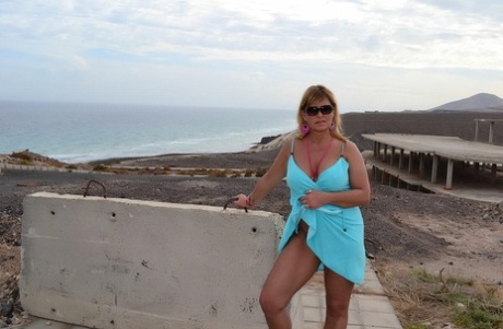 Middle-aged blonde Nude Chrissy shows her naked body at a desolate location