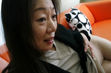 Mature brunette Yoshiko Makihara is revealing her hairy pussy in close up