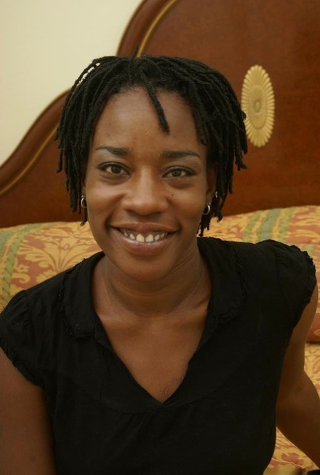 Mature ebony Cat is undressing her lingerie and playing with tits