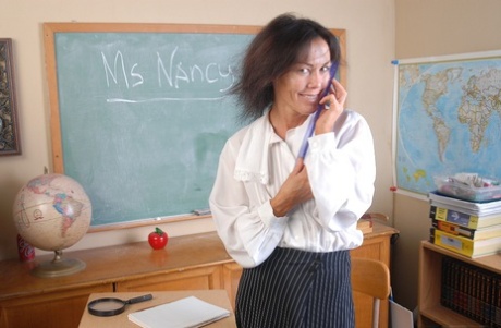 Aged teacher Nancy spreads her legs and dildoes her shaved mature cunt