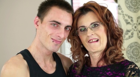 Horny granny Mayna May bangs her boy toy's big cock in glasses and mesh hose