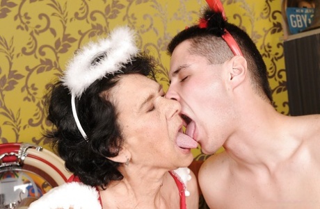Granny in a sexy uniform teases her pussy and gets banged hard