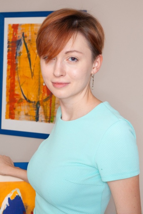Hairy lady Ginta shows a collection of her paintings and spreads her pussy