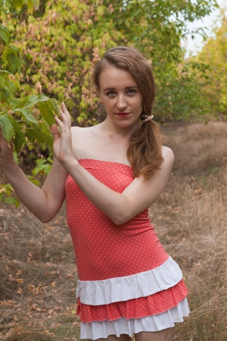 Petite Russian babe Emma Fantasy toying her hairy pussy with bananas outdoors