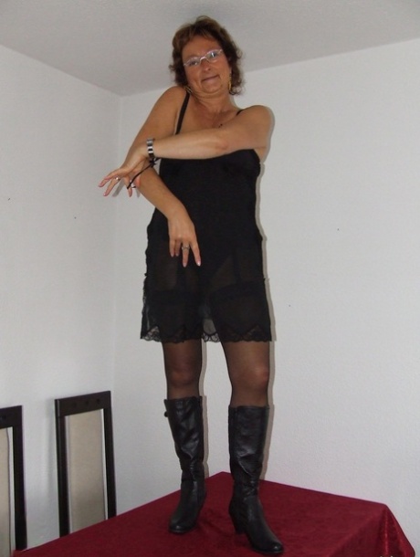 Kinky granny Gabriele removes her clothes and poses naked in a solo