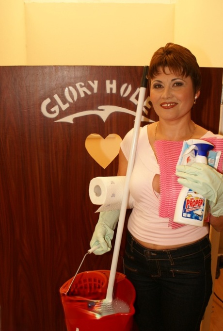 Short-haired cleaning lady Malinda finds a dick at the gloryhole and blows it