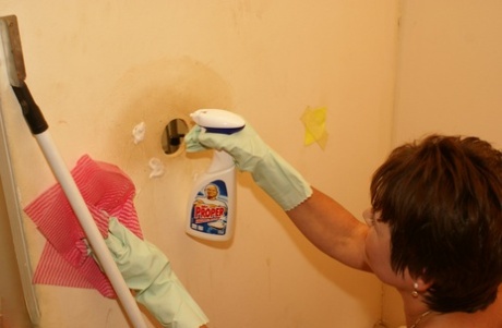Short-haired cleaning lady Malinda finds a dick at the gloryhole and blows it