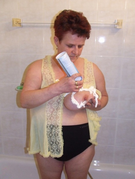 Chubby housewife Ingeborg plays with her saggy breasts in the bathroom