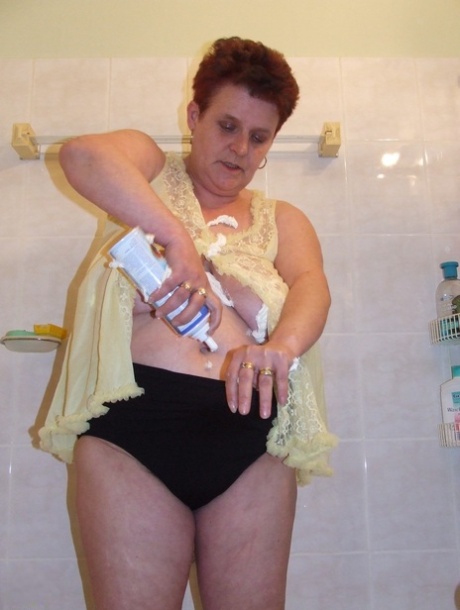 Chubby housewife Ingeborg plays with her saggy breasts in the bathroom