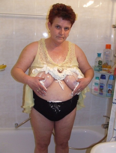 Chubby housewife Ingeborg plays with her saggy breasts in the bathroom